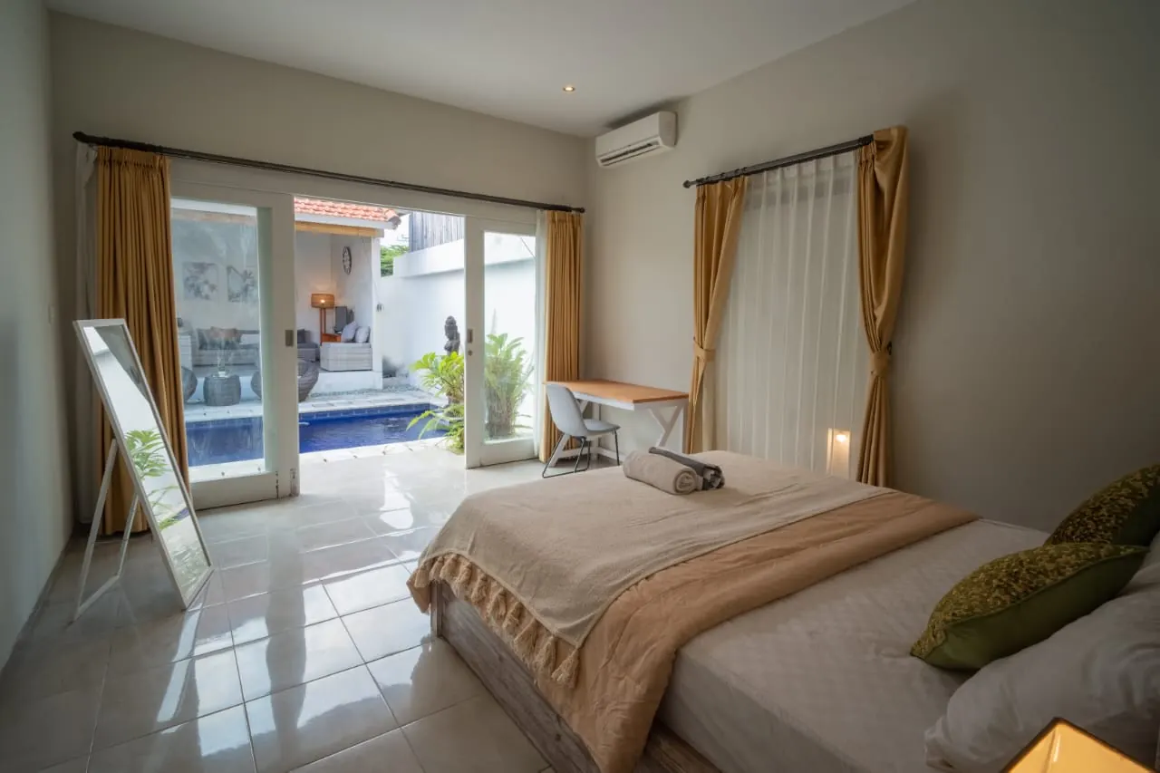 Bedroom with glass doors to the garden and pool