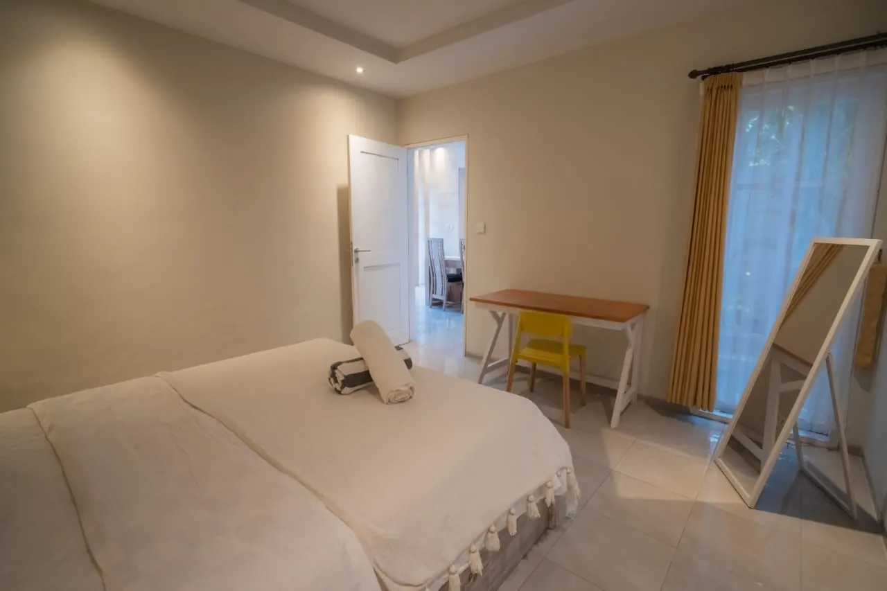 Bedroom with desk, opening to the living area