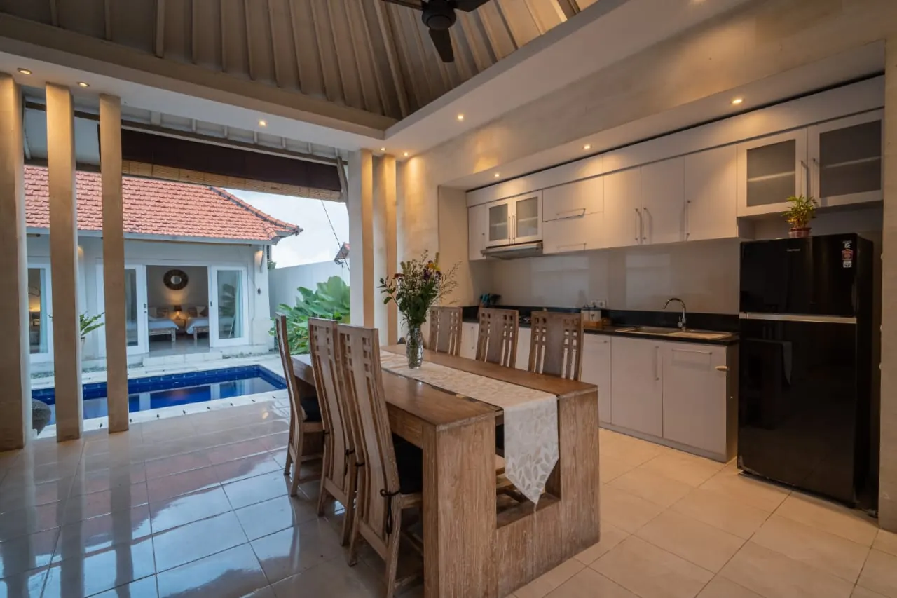 Kitchen with dining table for six overlooking the pool