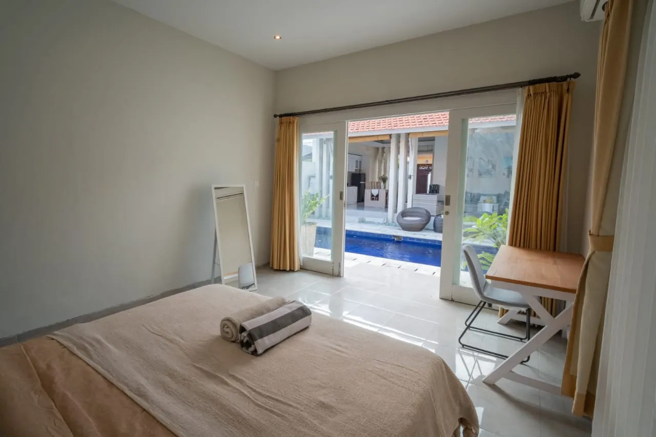 Bedroom with glass doors opening to the pool